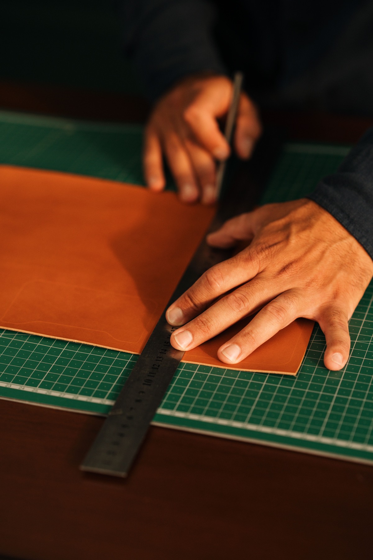 Handcrafting leather bag in our manufacturing workshop