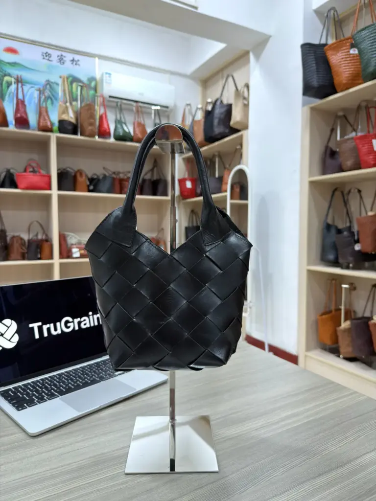 Black handbag with broad interlaced strips and rounded handles (TG-90695)