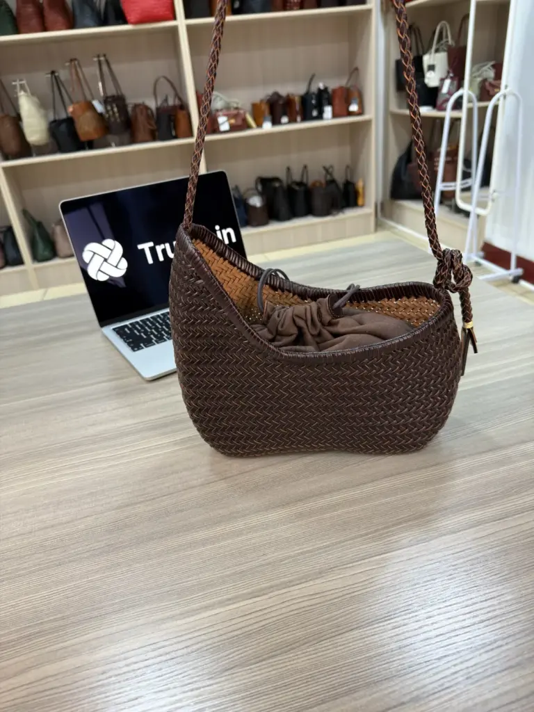 Brown curved woven shoulder bag with a long strap and hanging ties (TG-90757)