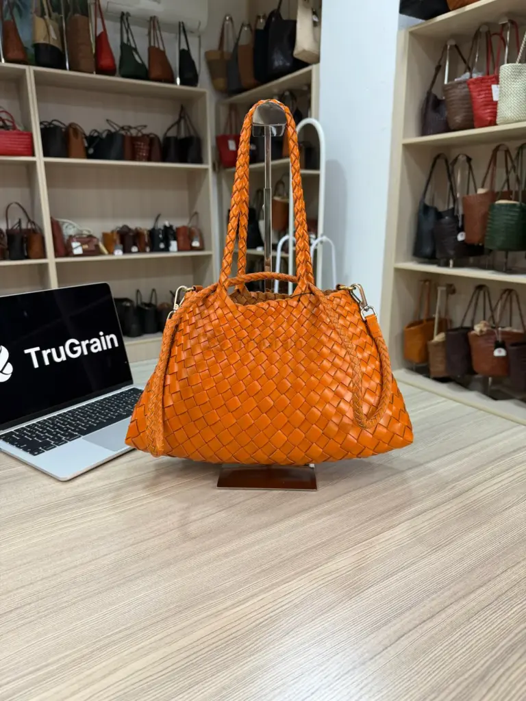 Orange handbag with broad interlaced strips and rounded handles (TG-90770)
