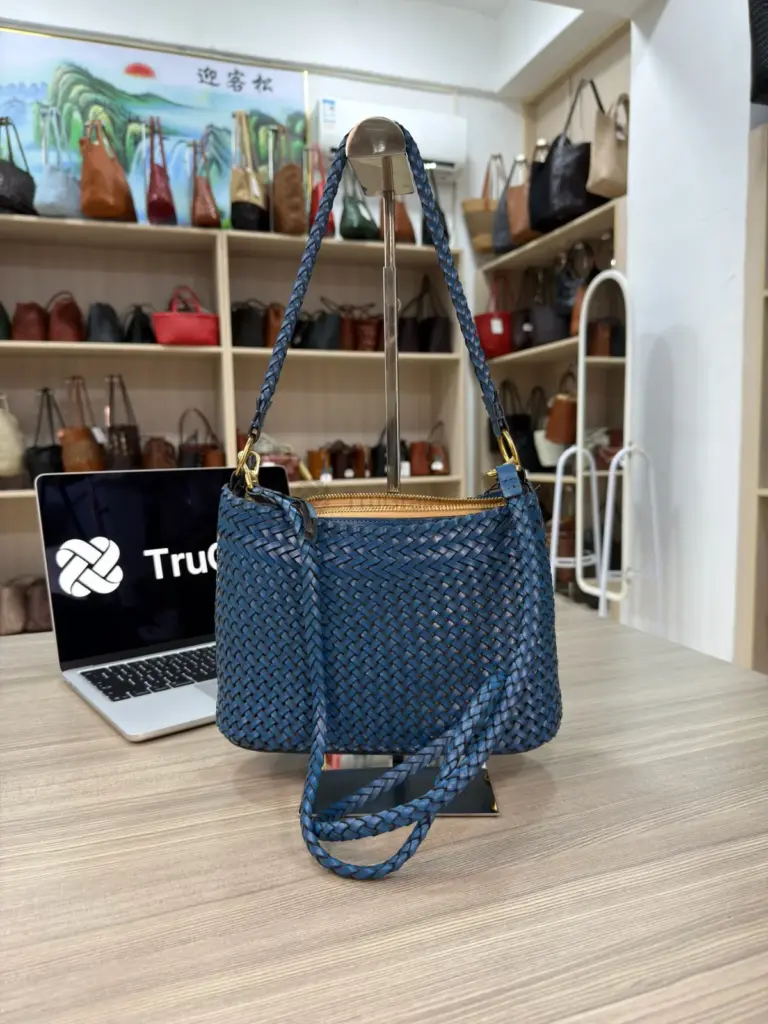 Blue woven bag with a long strap draped across the front (TG-90818)