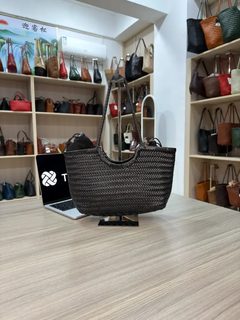 Black woven handbag with rounded handles and a curved upper edge (TG-90870)