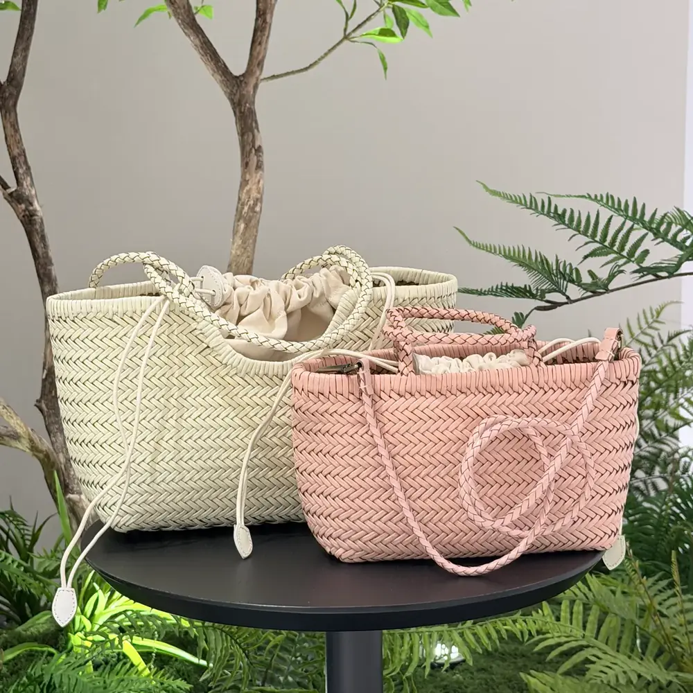 Cream woven leather tote TG-90004-1 and pink woven leather handbag TG-90032 shown together on a round table