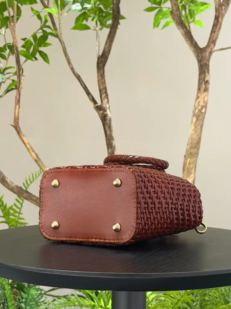 Base construction of a small square woven leather bag