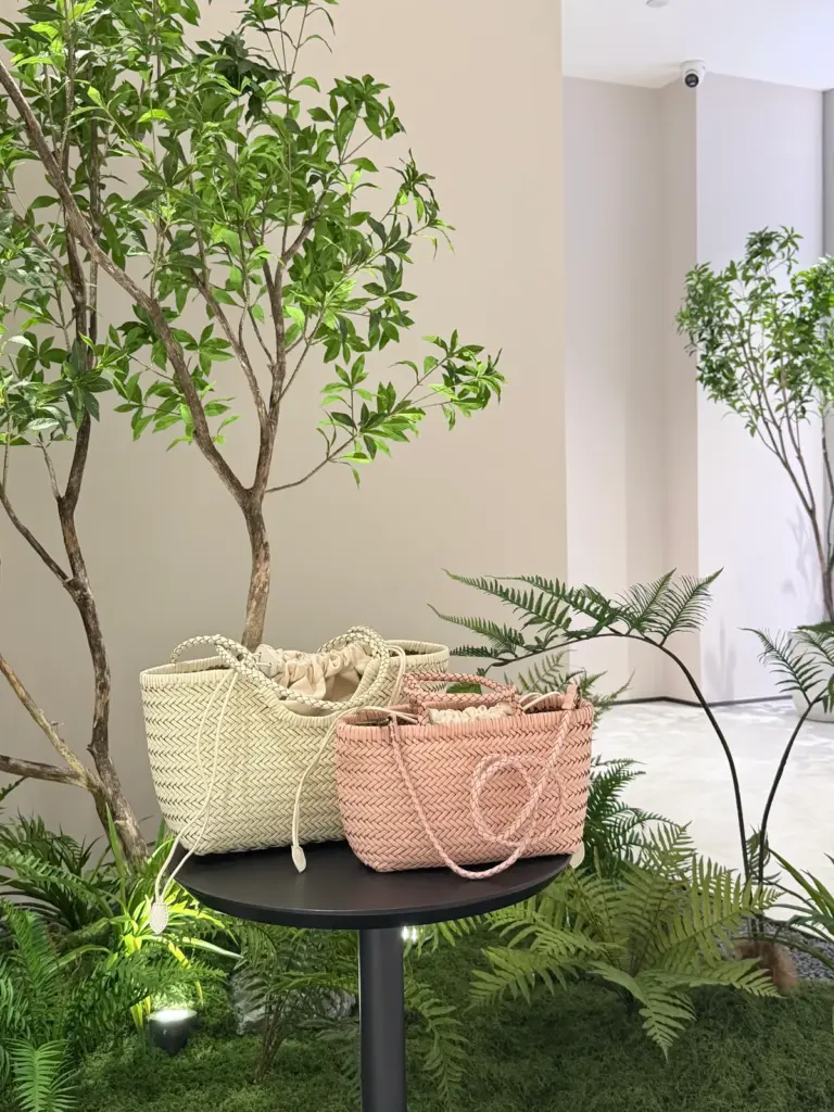 Cream woven leather tote TG-90004-1 and pink woven leather handbag TG-90032 arranged side by side on a table